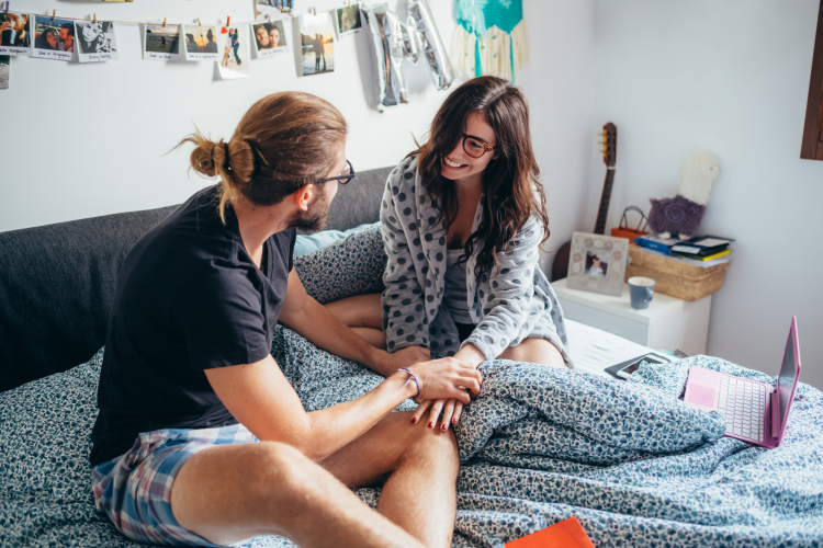 couple sitting in bed with a laptop