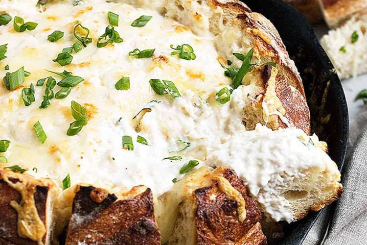 warm skillet crab dip in a sourdough bread bowl can go straight from the oven to the table