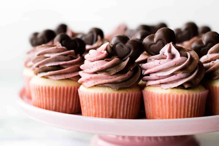 cupid's cupcakes are finished with a beautiful strawberry chocolate swirl