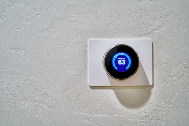 a nest thermostat on a white wall