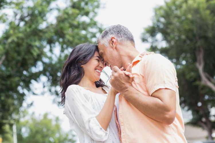 middle-aged couples slow dancing outdoors