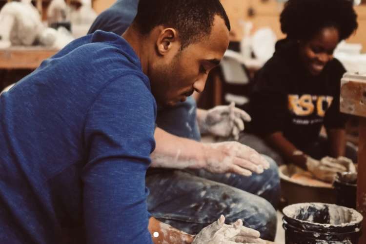 couple spinning clay pots at mudfire pottery