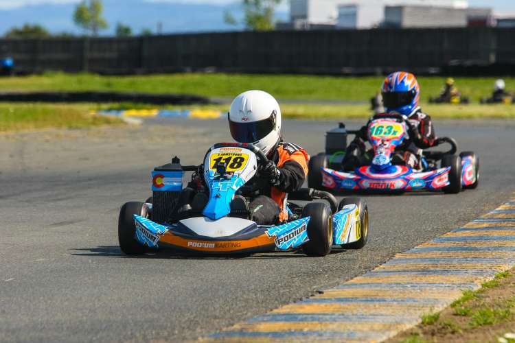 drivers racing go-karts around a racetrack