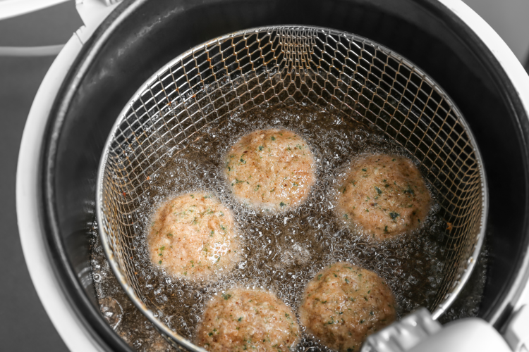 food deep frying in a large pot