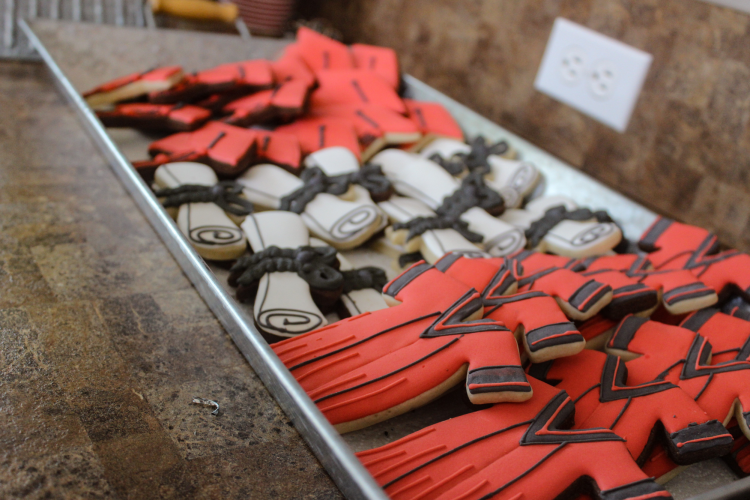 gown and diploma shaped sugar cookies on a dessert table