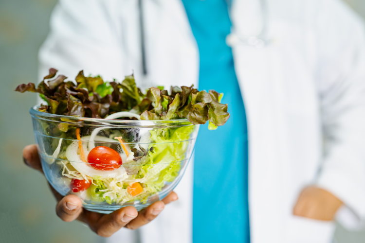 dietician holding a bowl of salad