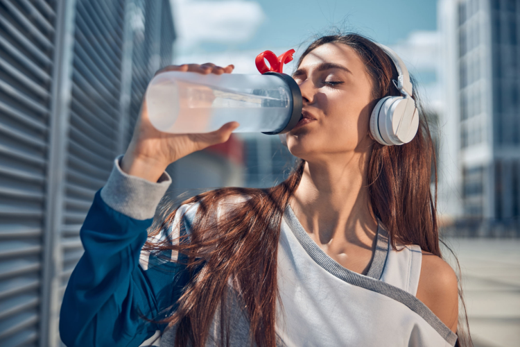 woman drinking water from bottle