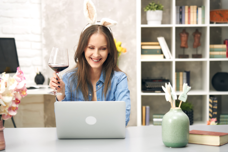 woman laughing with bunny ears on during a virtual easter party