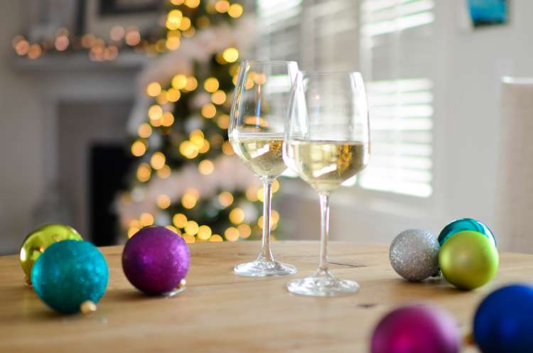 Wine glasses and christmas ornaments on a shelf