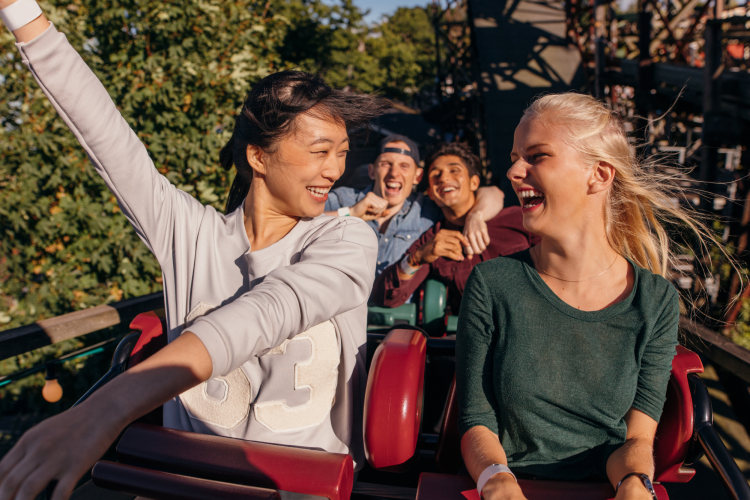 two women riding on a roller coaster