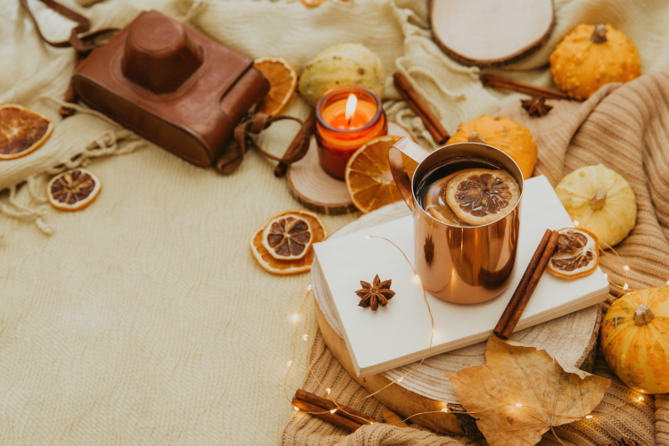 flat lay with apple cider, organge slices and pumpkins for fall