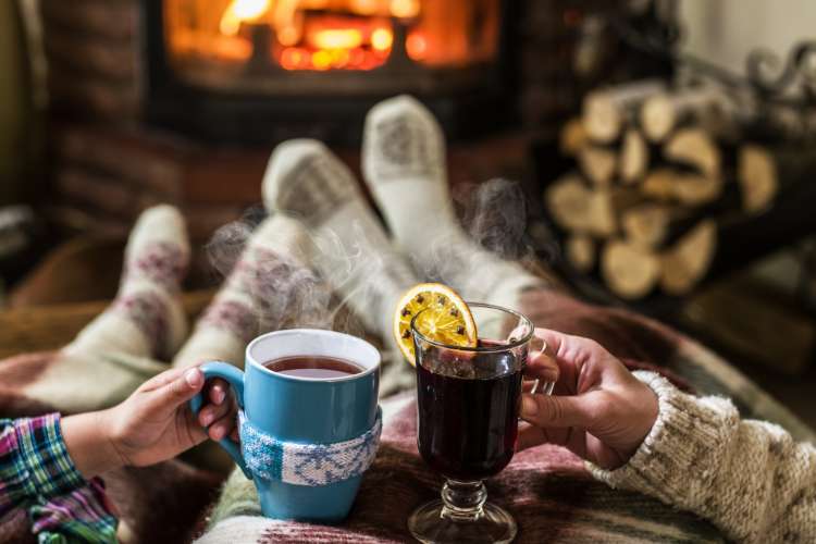 couple snuggling up by the fireplace