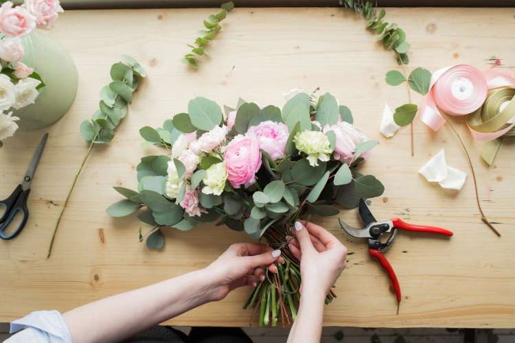 woman making floral arrangement