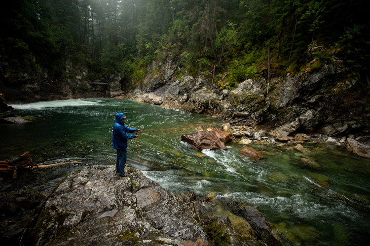 man fly-fishing in a rolling brook