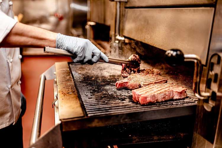 chef grilling steaks at gene & georgetti chicago