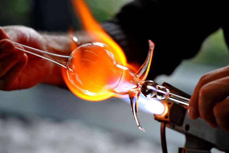 artist blowing glass