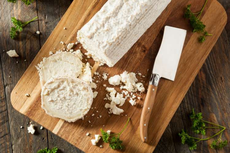 goat cheese on a wooden cutting board