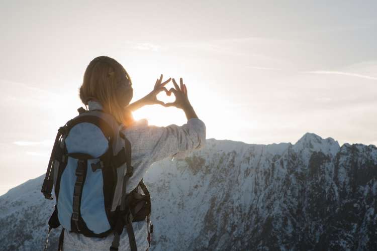 woman hiking a snowy mountain