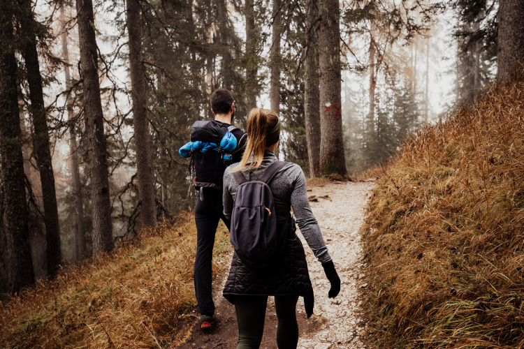 couple hiking on a wooded trail