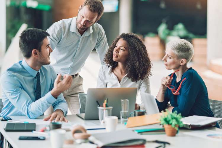 Employees listening seriously to a coworker talking