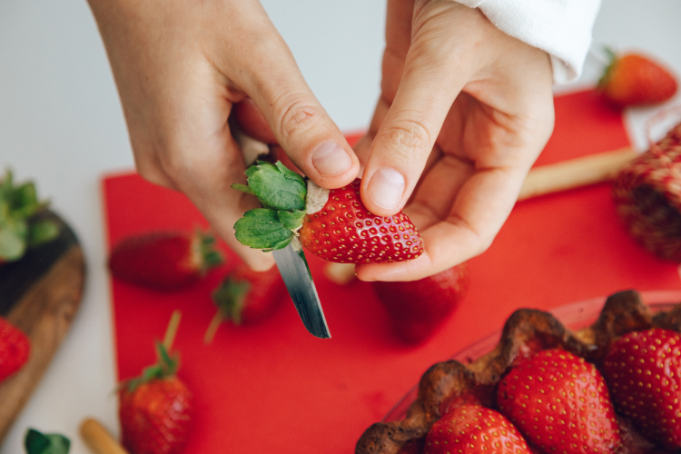 hulling strawberries with a paring knife