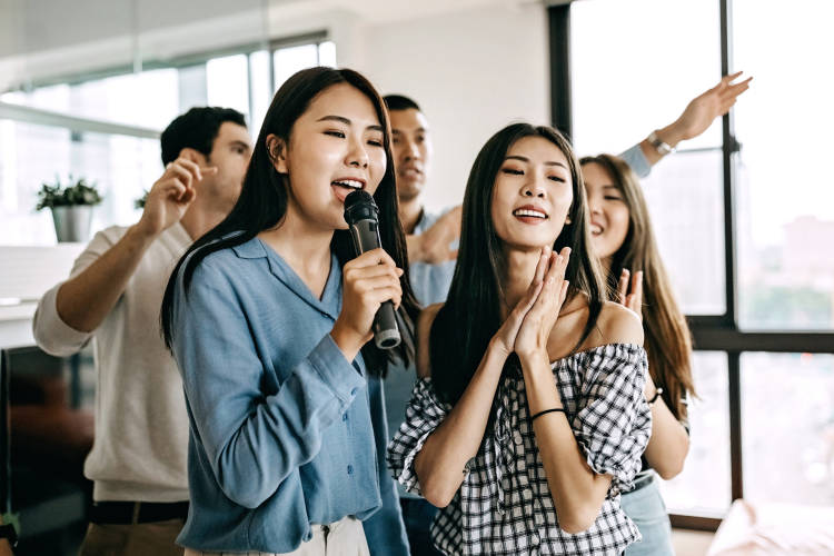 coworkers singing karaoke together