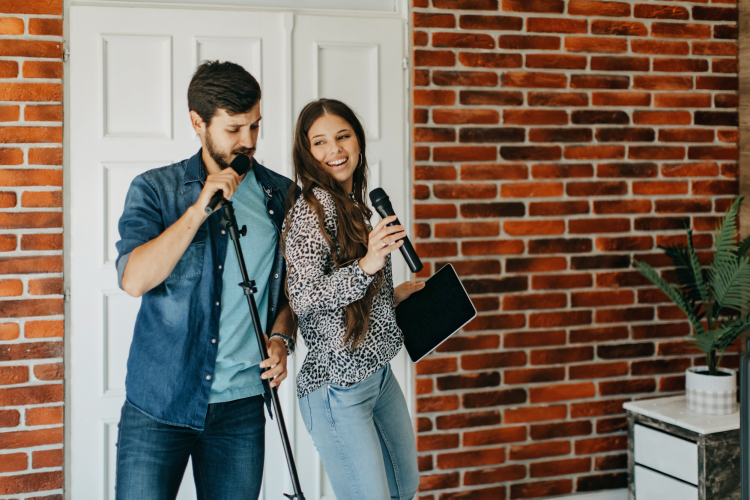 couple singing karaoke at home