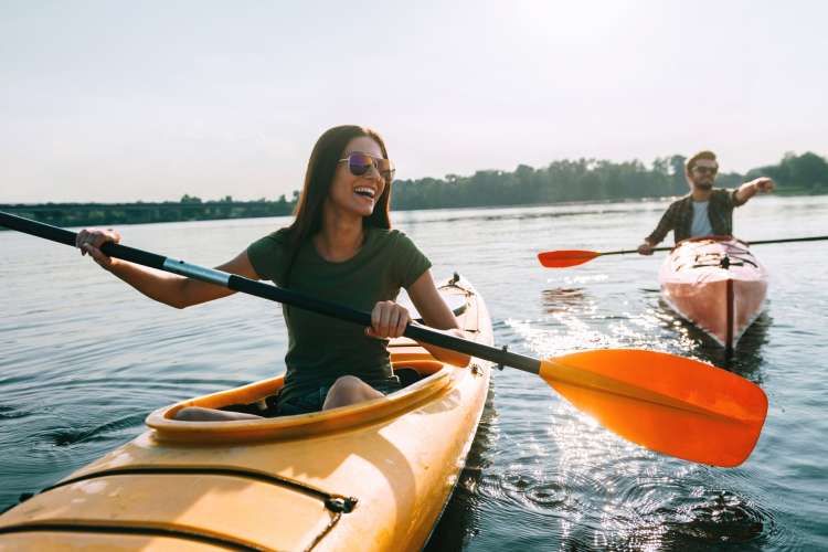 young couple kayaking on a date