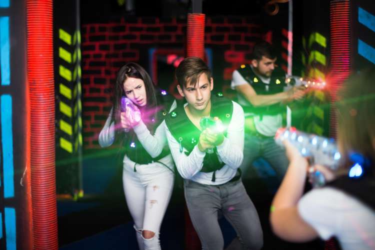 group of friends playing laser tag