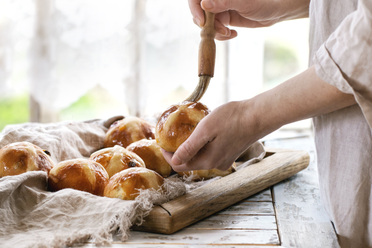 chef making hot cross buns