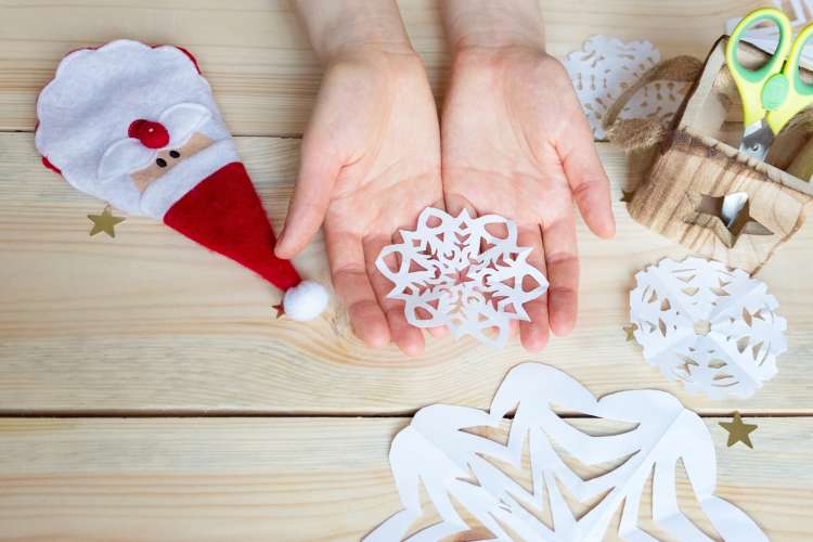 creating paper snowflakes together is a fun christmas date idea