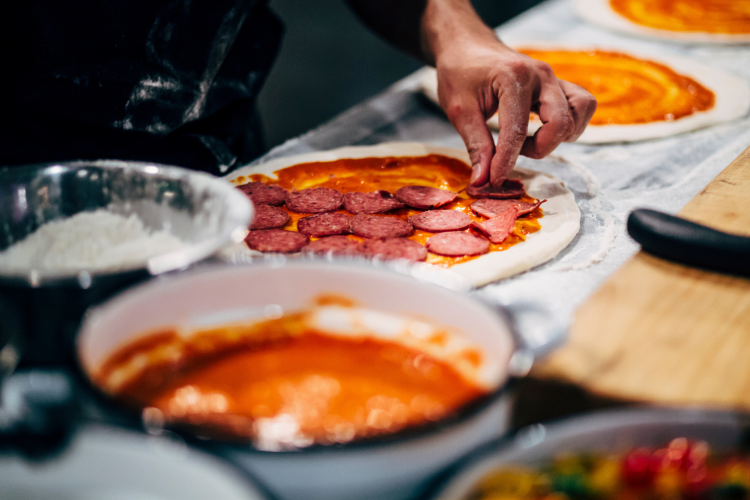 line cook making pizzas