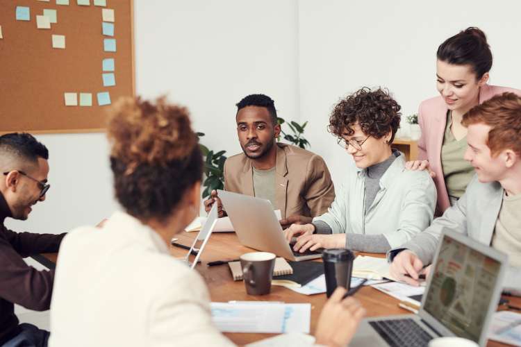 Colleagues working positively together around a conference table