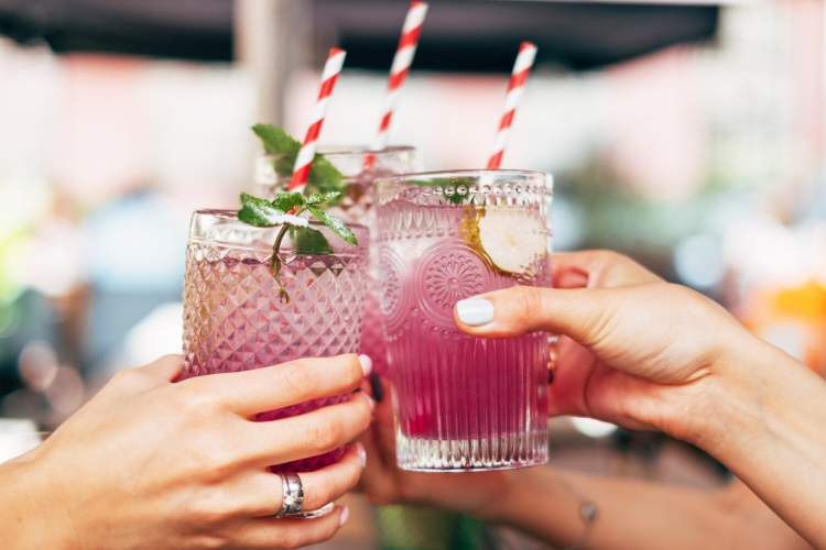 friends toasting colorful mocktails