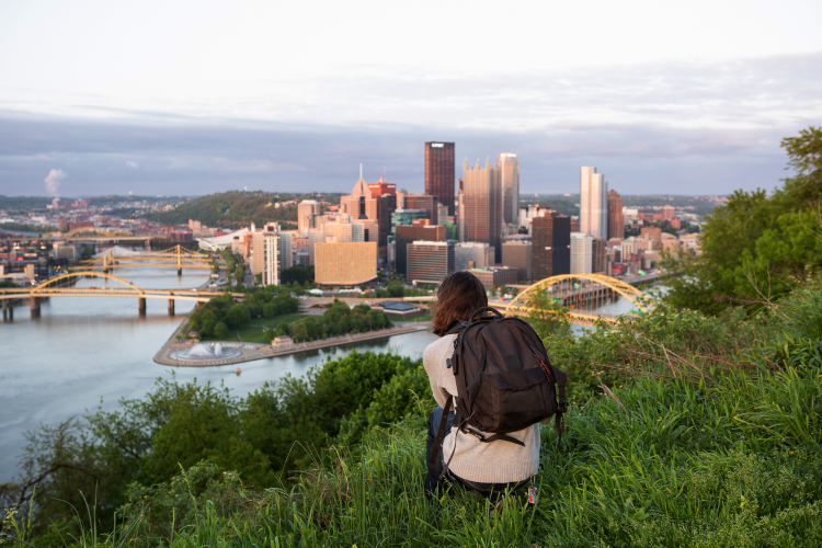 tourist photographing pittsburgh skyline from mount washington