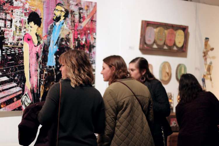 people visiting an art gallery during an art crawl