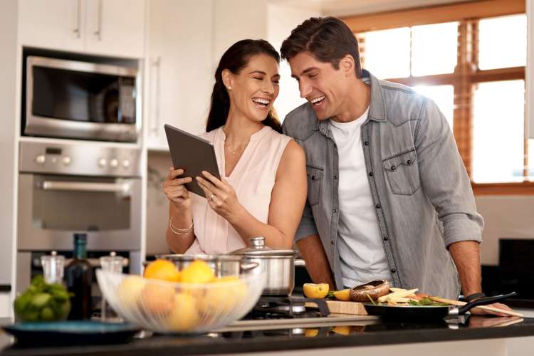 a couple doing an online cooking class together