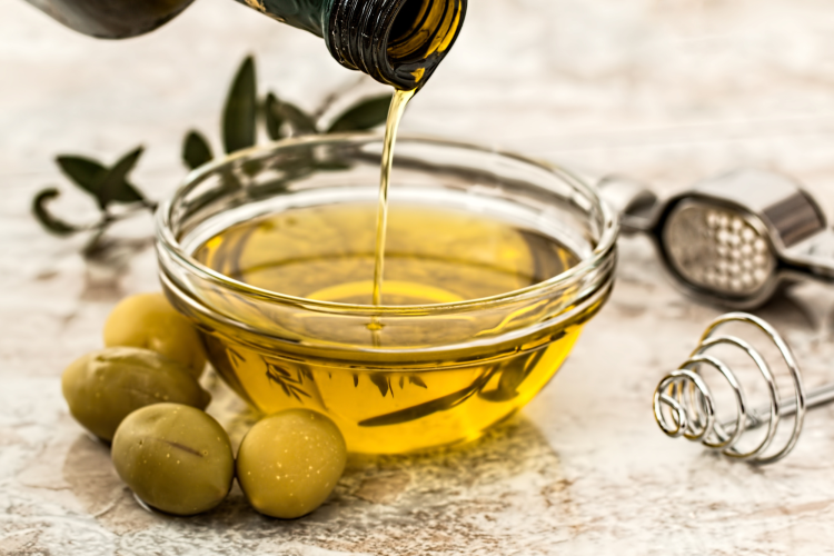 olive oil poured into glass bowl