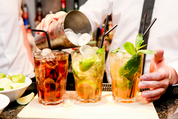 mixologist making craft cocktails at a bar