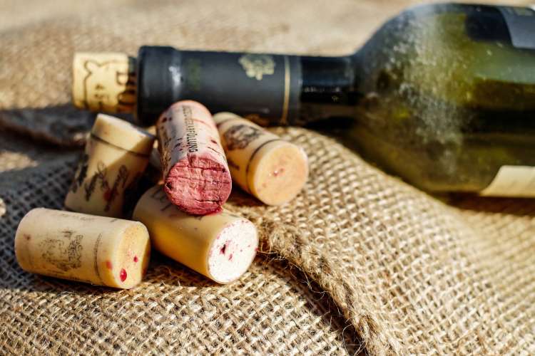 wine bottle with several used corks