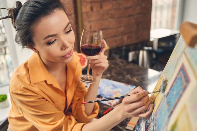 young woman enjoying a paint and sip class