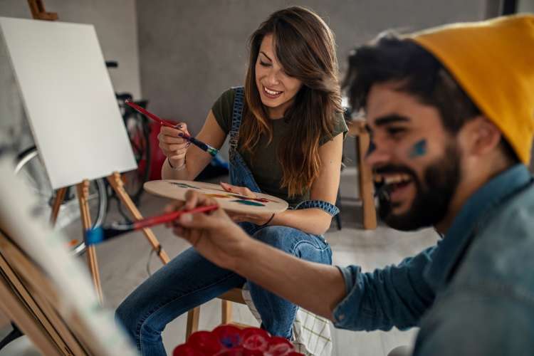 couple painting on canvases together