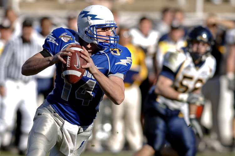 football player holding the ball during a game