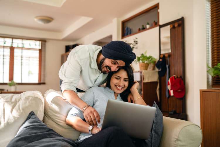 young couple playing virtual games with friends over zoom