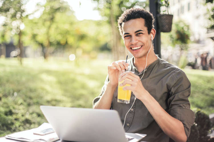 man drinking a cocktail outside during a virtual happy hour