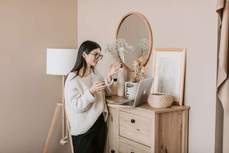 woman taking colleagues on a house tour during a zoom happy hour