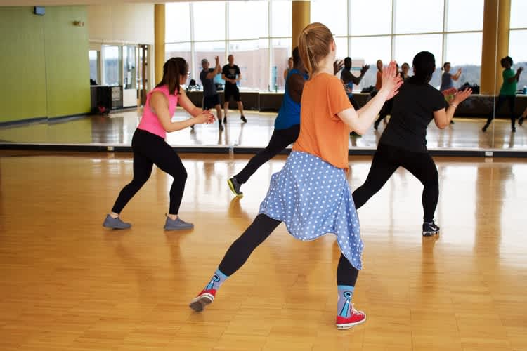 A group learns a dance routine a part of creative team building activities