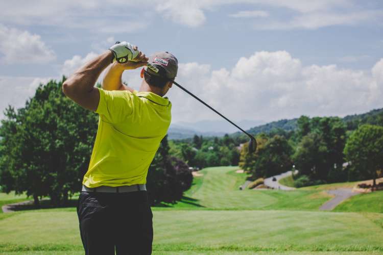 dad playing golf on the course