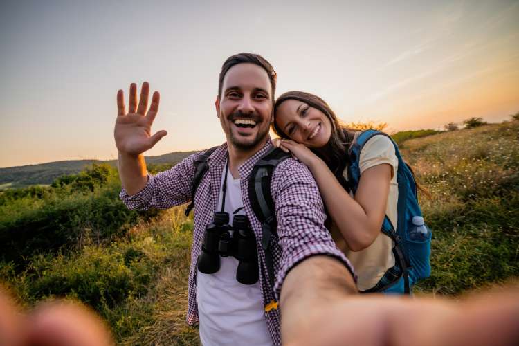 young couple taking a selfie on a hike