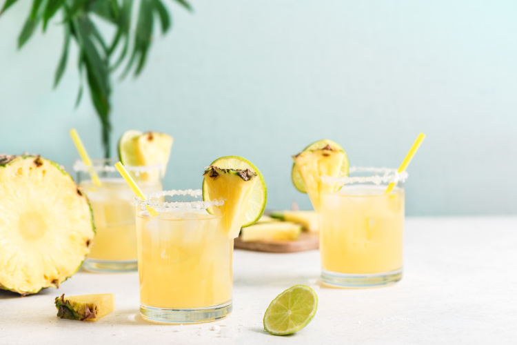 margaritas garnished with pineapple